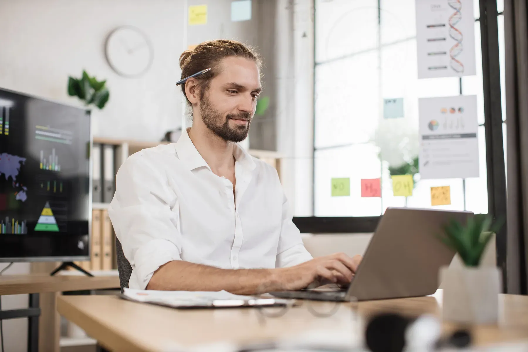 A professional reviewing business reports at a Grand Water Offices workspace.